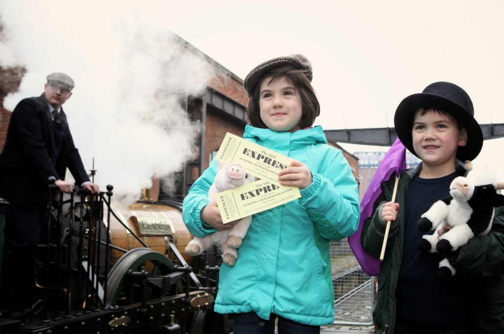 Brother and sister standing by 1830 Express with tickets - Science Museum Group Collection - © The Board of Trustees of the Science Museum - Jonty Wilde