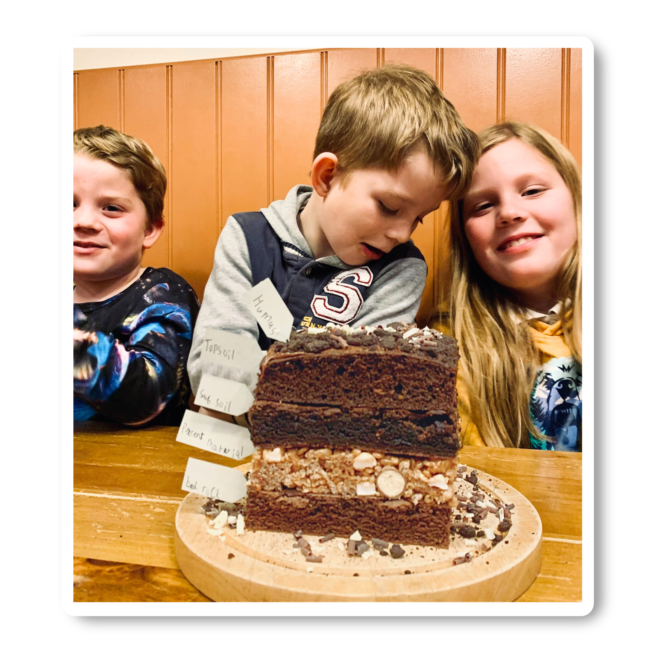 Three children with chocolate cake experiment