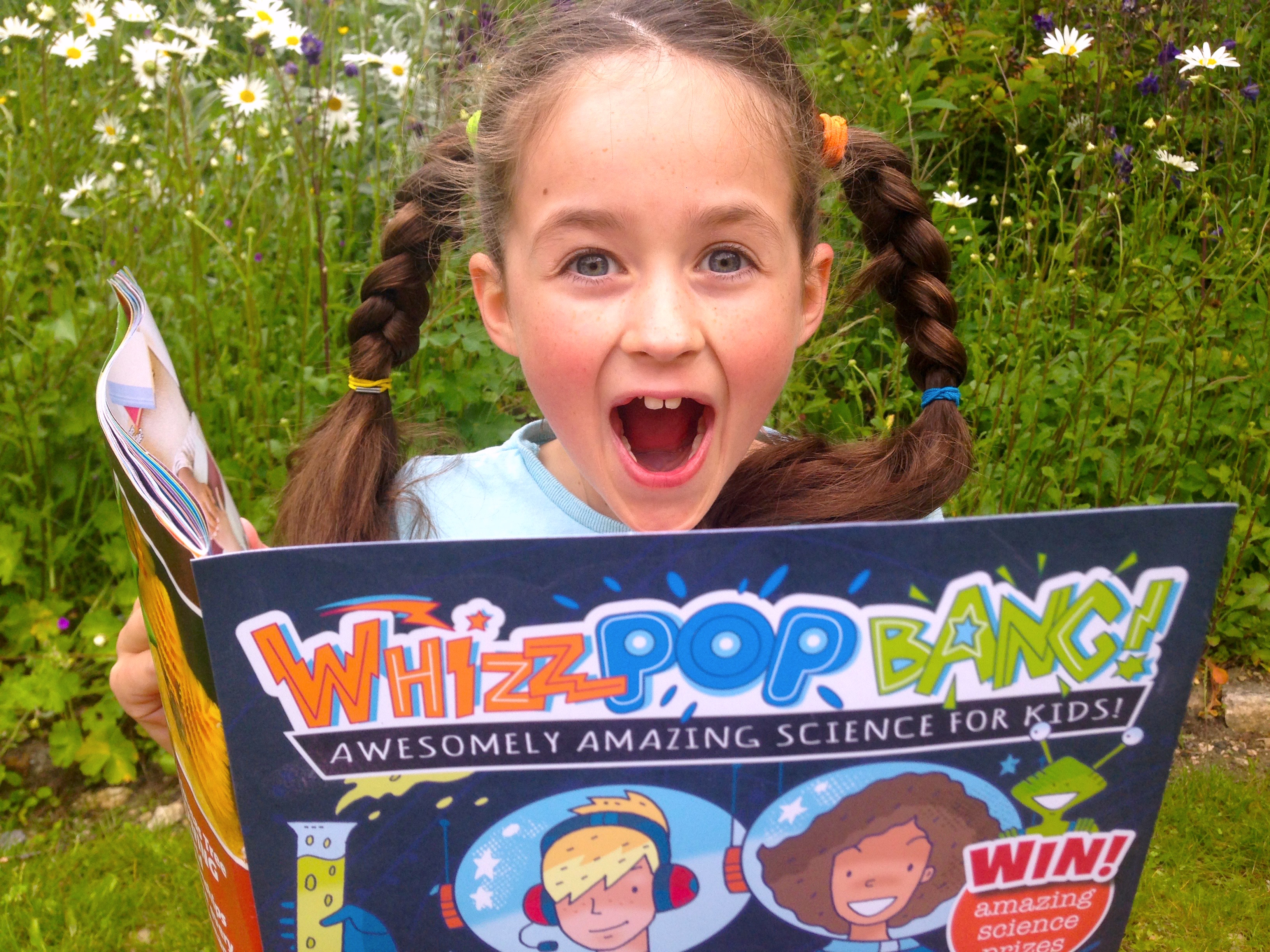 Child reading Whizz Pop Bang magazine